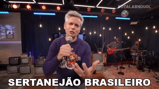 a man singing into a microphone with the words sertanejao brasileiro on the bottom