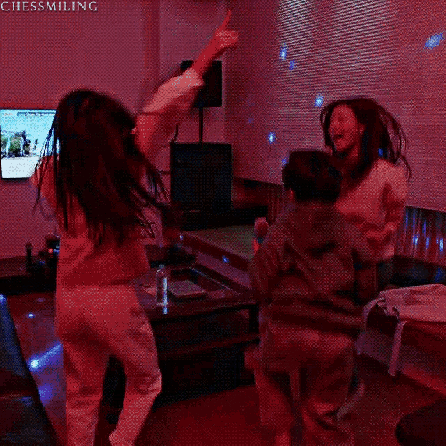 a group of people are dancing in a living room with the caption chess smiling above them