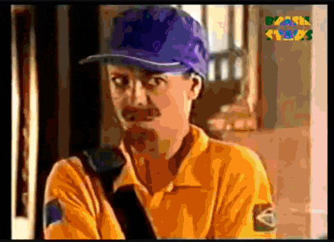 a man wearing a yellow shirt and a blue hat is on a tv screen that says brasil
