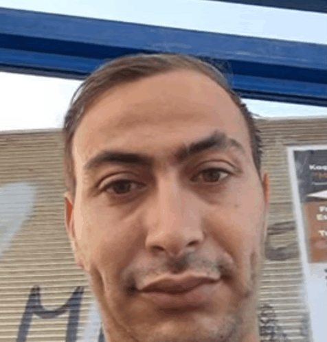 a close up of a man 's face with a sign in the background that says king