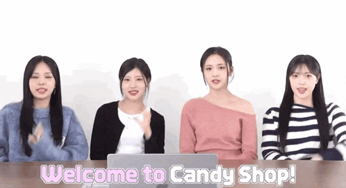 a group of girls are sitting at a table with the words welcome to candy shop