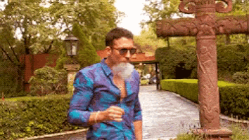 a man in a blue shirt smoking a cigarette