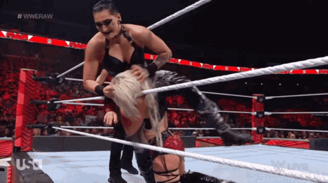 two women in a wrestling ring with the hashtag #wweraw on the bottom