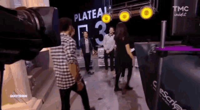 a man in a plaid shirt stands in front of a sign that says plateau 3