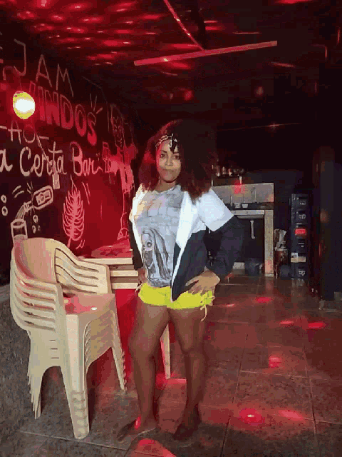 a woman stands in front of a wall that says " jam "