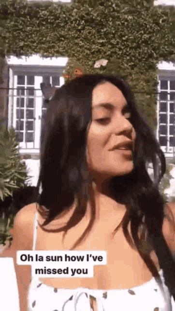 a woman in a white dress says oh la sun how i 've missed you ..