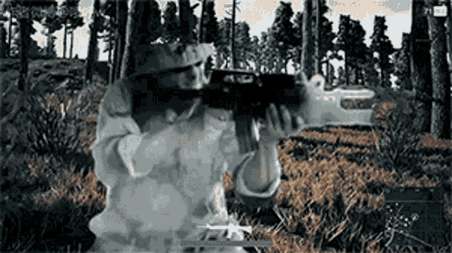 a man is holding a gun in a video game with smoke coming out of his face .