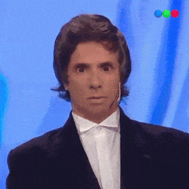 a man in a tuxedo with a microphone on his head
