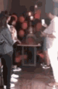 a blurry picture of a group of people standing in a room .