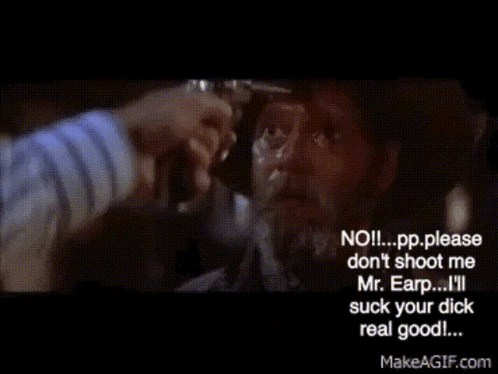a man in a striped shirt is holding a gun to another man 's face