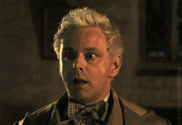 a close up of a man 's face with a surprised look on his face and the words fuckyeahwoodmen below him