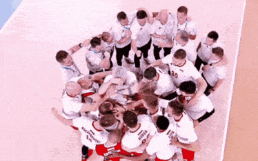 a group of men are huddled together with one wearing the number 30
