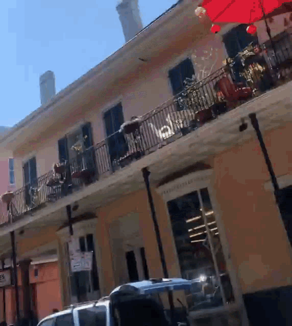 a building with a balcony and a sign that says ' no parking ' on it