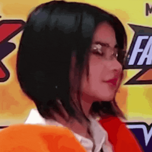 a close up of a woman 's face in front of a sign that says fa on it