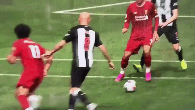 a soccer player wearing a number 10 jersey kicks the ball
