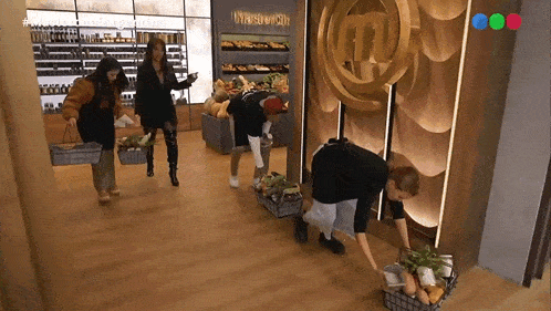a group of people carrying baskets of vegetables in front of a masterchef logo