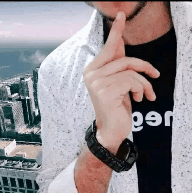 a man wearing a shirt that says jeep holds his finger to his mouth