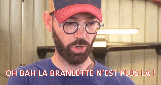 a man with a beard wearing glasses and a red hat says oh bah la branlette n'est plus la