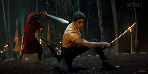 two men are fighting with swords and netflix is displayed in the background