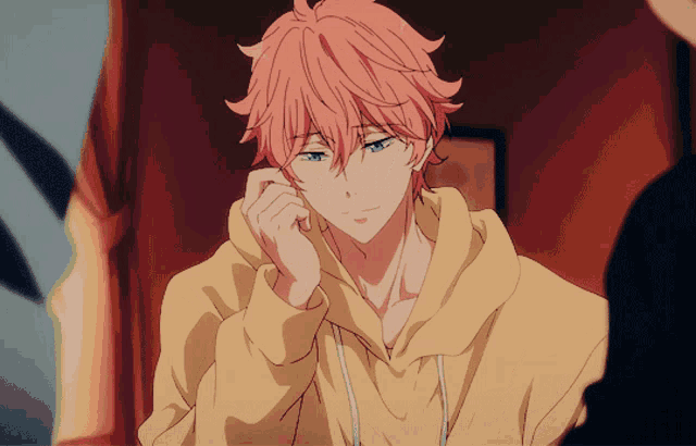 a boy with pink hair is wearing a yellow sweatshirt