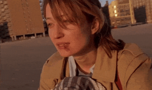 a woman with a bruise on her face looks down