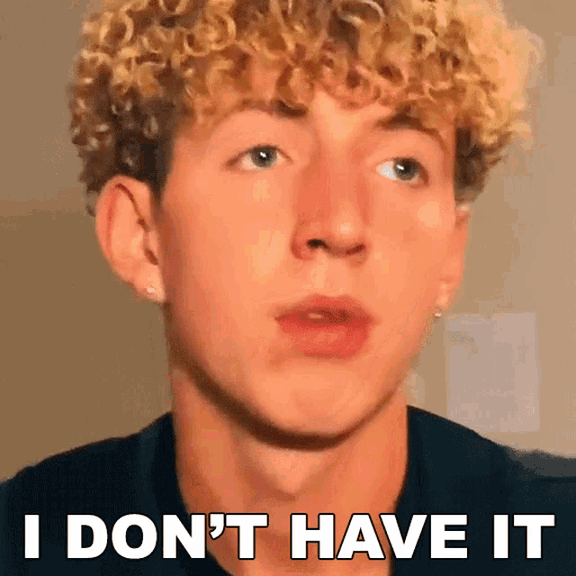 a young man with curly hair has the words i don 't have it on his face