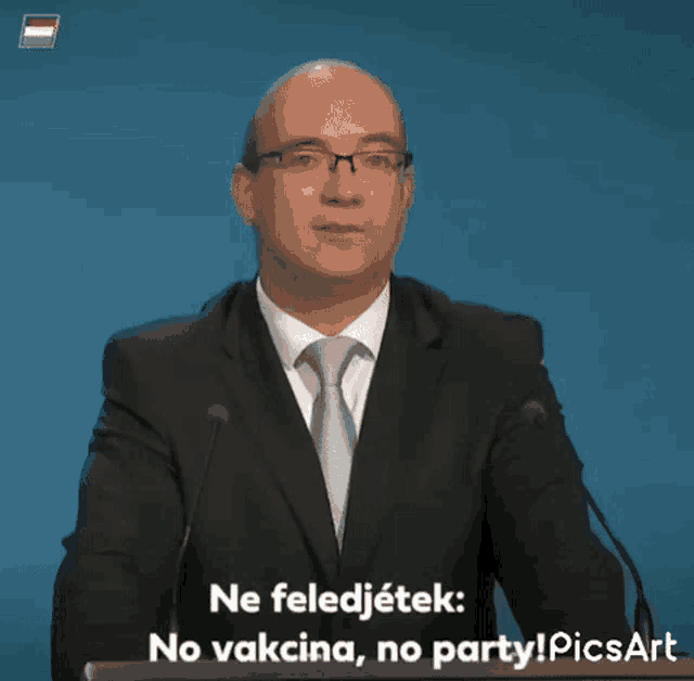 a man in a suit and tie is giving a speech with the words ne feledjetek no vacina no party picsart
