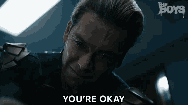 a man says you 're okay in front of a boys logo