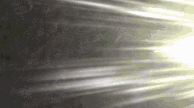 the sun is shining through the clouds and rays of light are coming out of the sky .