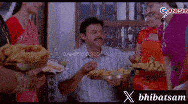 a group of people are gathered around a man holding a plate of food and a banner that says x bhibatsam