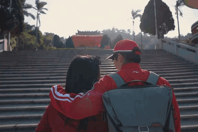 a man and a woman are walking down a set of steps