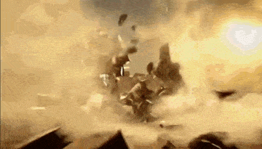 a large explosion with a lot of smoke coming out of it and a lot of pieces of metal flying in the air .