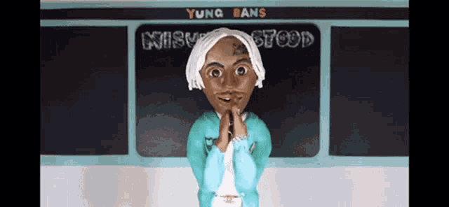 a figurine of yung bans is standing in front of a chalkboard