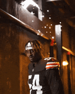 a football player wearing a headband that says swns on it