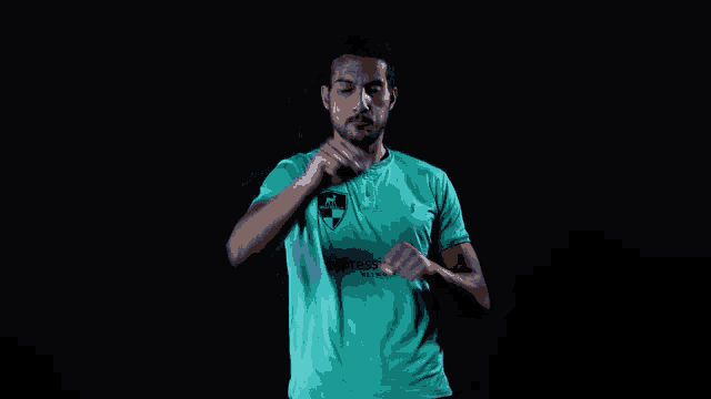 a man wearing a t-shirt that says adidas on the front