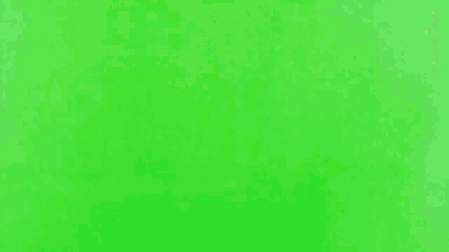 a helicopter is flying on a green screen with smoke coming out of it