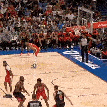 a basketball game is being played on a court with a banner that says state farm