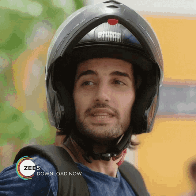 a man wearing a helmet with the words zees download now below him
