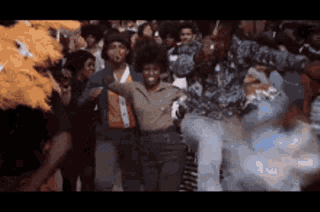 a group of people are dancing together in a dark room