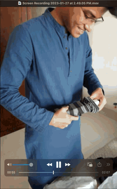 a screenshot of a screen recording of a man holding an umbrella