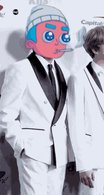 a man in a tuxedo smoking a cigarette in front of a capital one logo