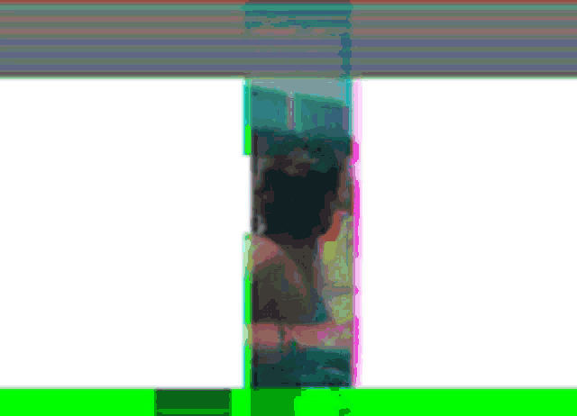a blurry picture of a woman sitting in a bathtub with a green border .