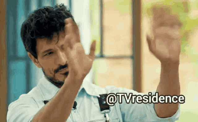 a man with a beard is giving a thumbs up with the words @tvresidence behind him