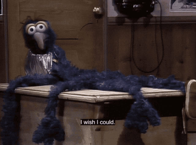 a sesame street character says i wish i could while sitting on a table