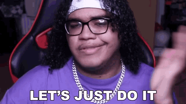 a man with curly hair wearing glasses and a purple shirt says let 's just do it