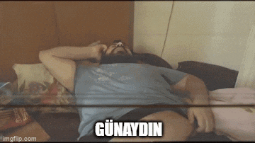 a man with a beard is laying on a bed with the word günaydin written above him