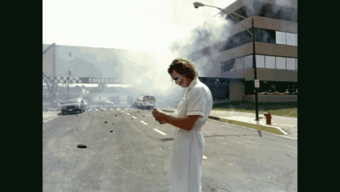 a nurse stands in front of a building that says emergency