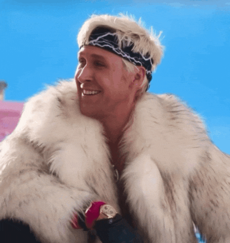 a man wearing a fur coat and a headband smiles