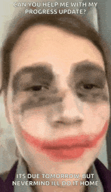 a close up of a person 's face with a joker face paint on it .