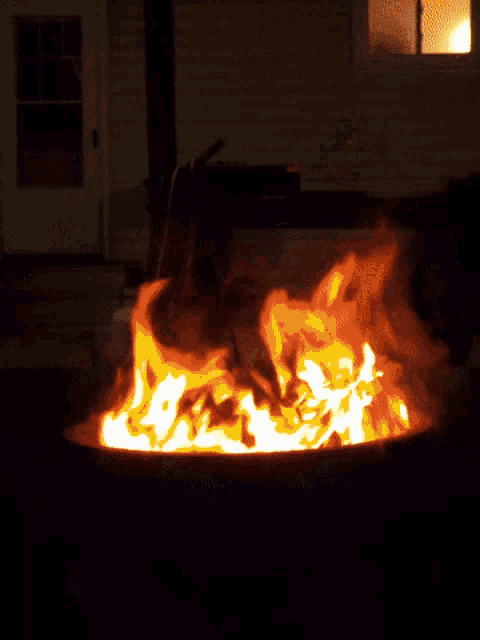 a fire pit with a lot of flames in it